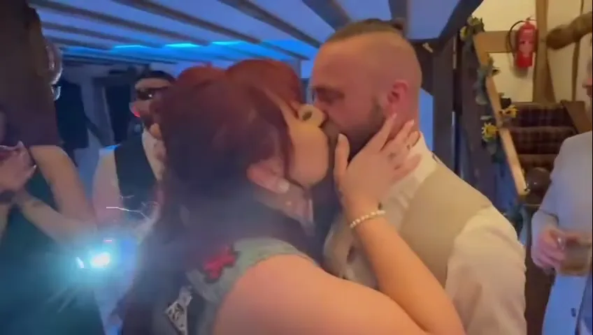 Couple kissing under blue party lights