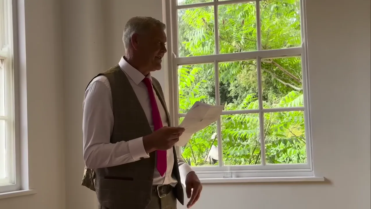 A wedding speech by a sunlit window